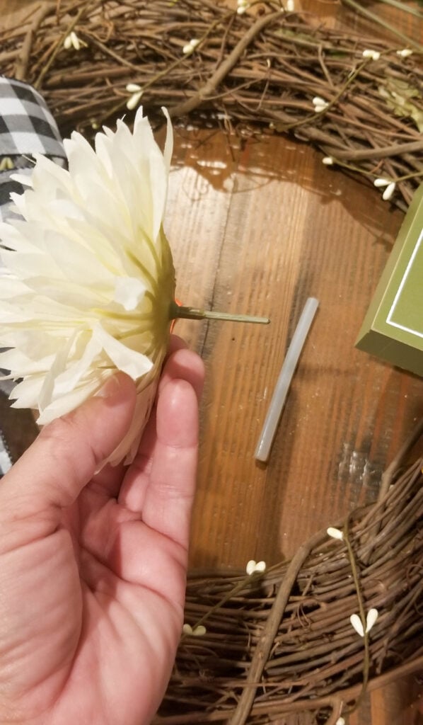 cutting the flowers down to add to the fall wreath