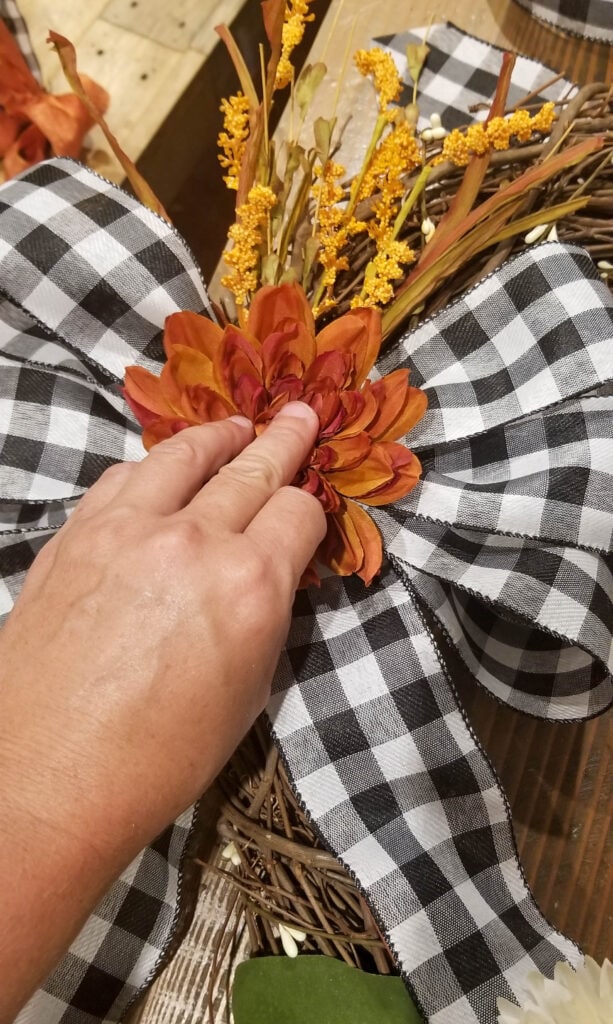 adding a chrysanthemum to the middle of the fall wreath bow