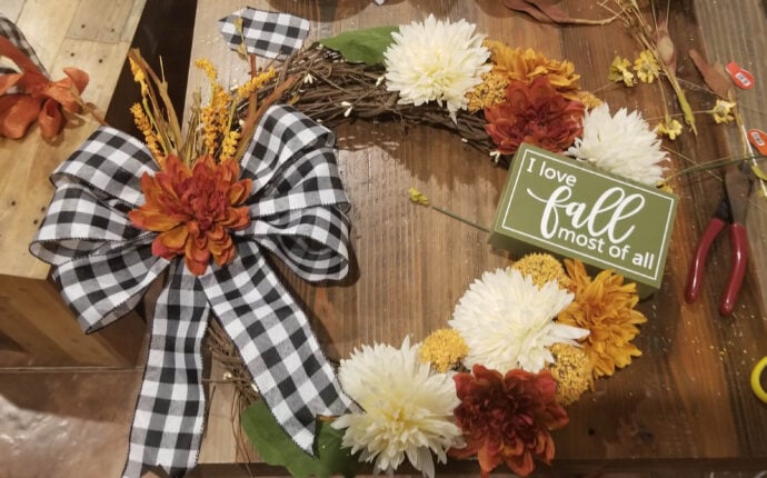 adding the large green leaves onto the fall grapevine wreath