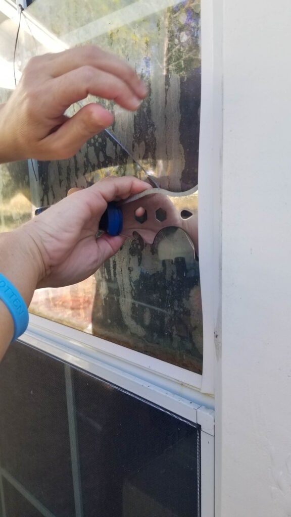 removing the glazing bead from the broken window that needs window glass replacement