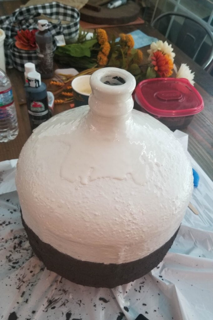 pouring epoxy over white top part of vase