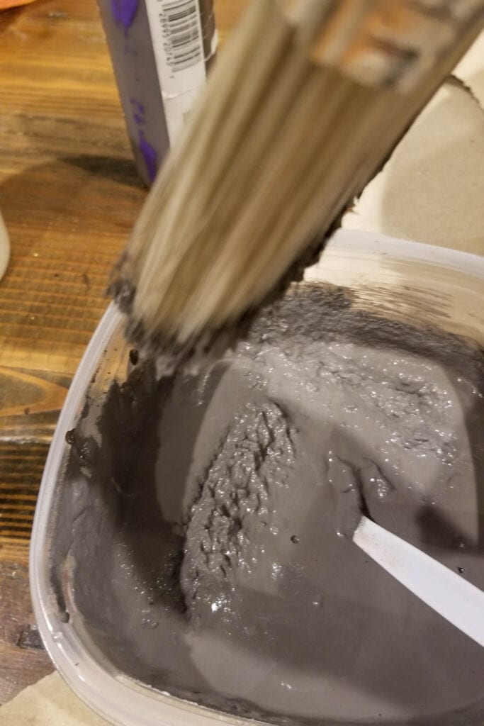 mixing baking soda into gray paint to make the stone effect on vases