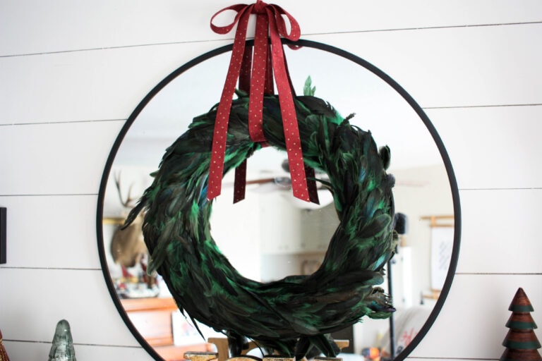 Green feather wreath with red ribbon for Christmas