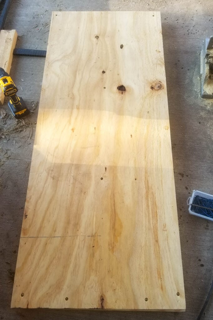 adding the plywood base to the wood cart