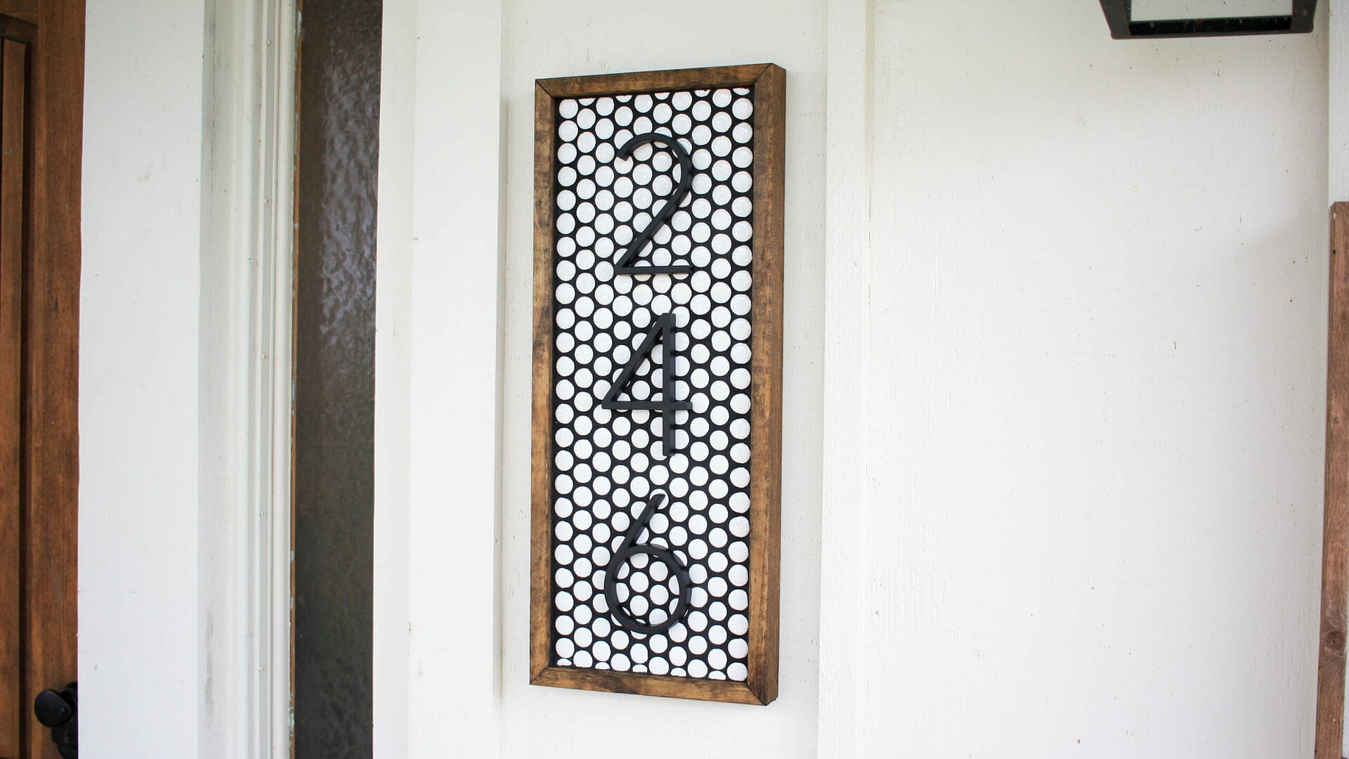 white Penny tile makes the background of this DIY house number sign