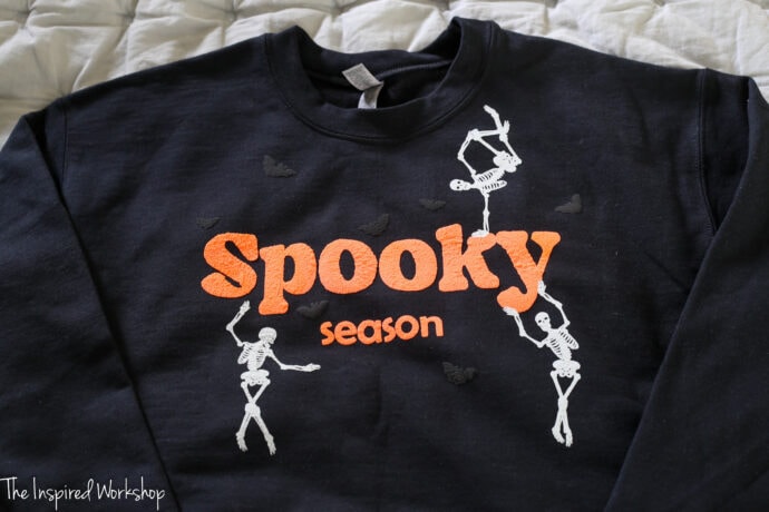 spooky season sweatshirt with skeletons and bats made with puffy vinyl cut on the xtool m1