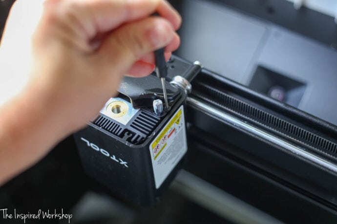 unscrewing the bottom plate of the laser 