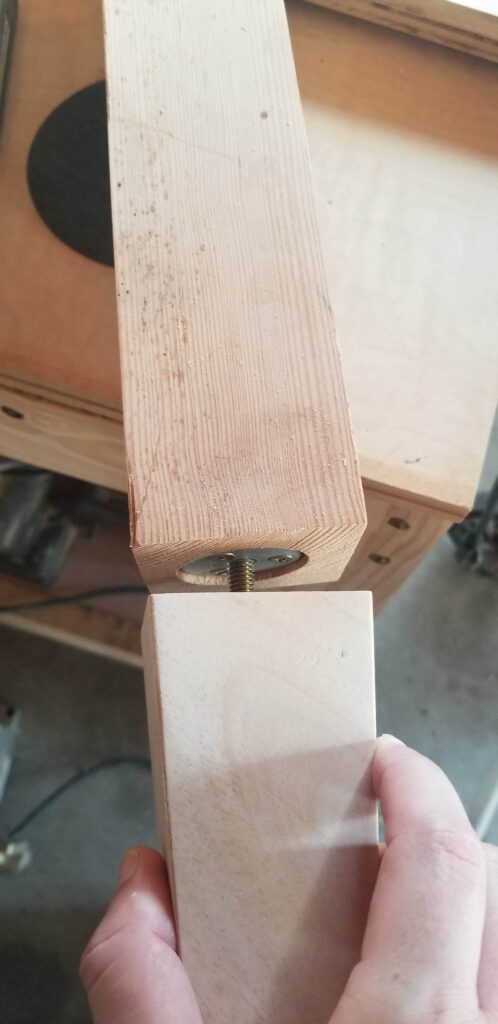 screwing the furniture foot into place