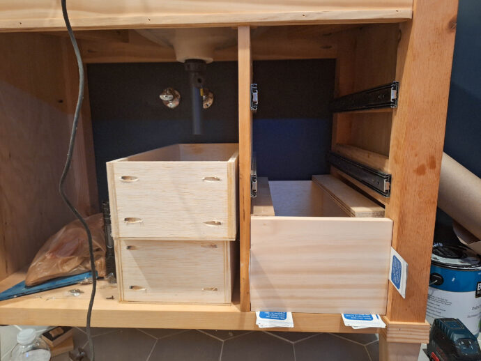 drawer boxes sitting inside the half finished vanity