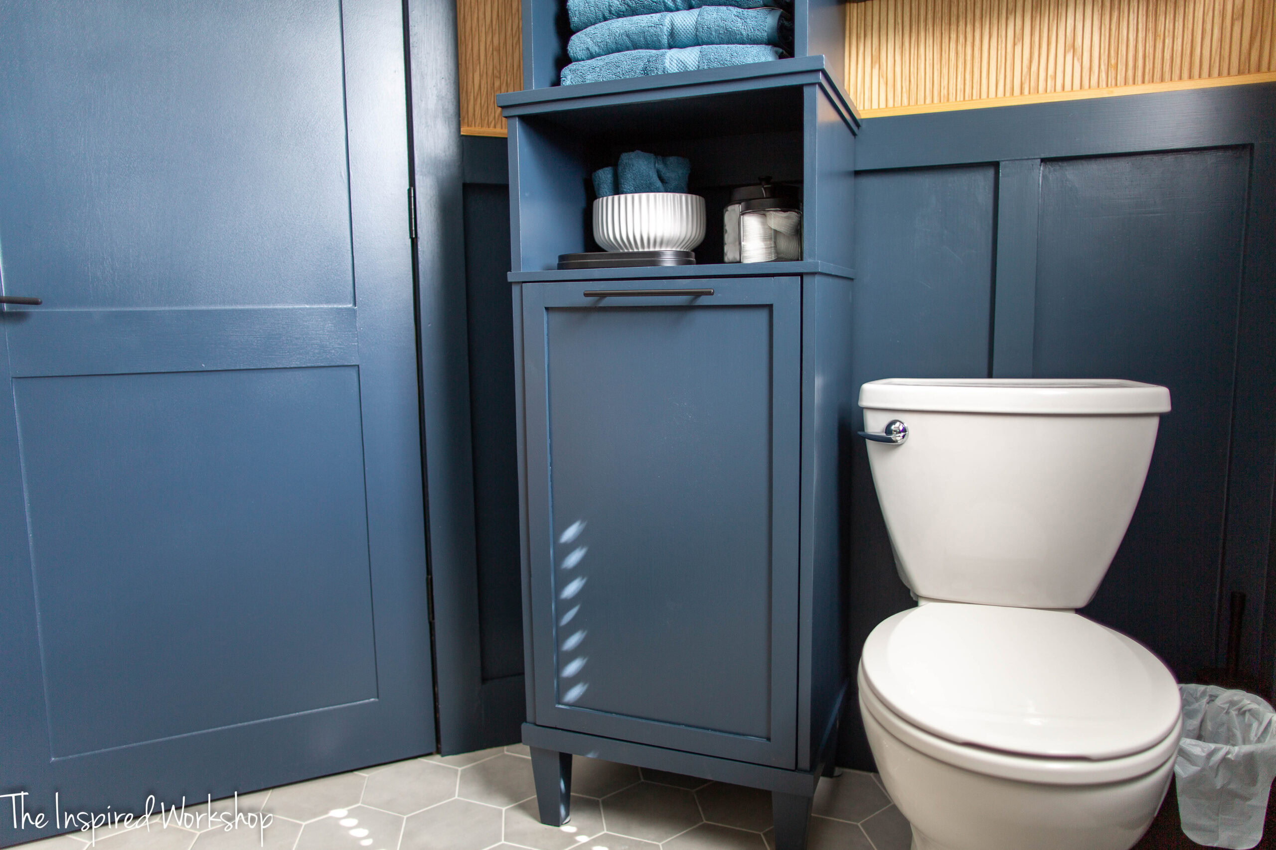 up close view of the linen cabinet base, showing the laundry hamper bottom