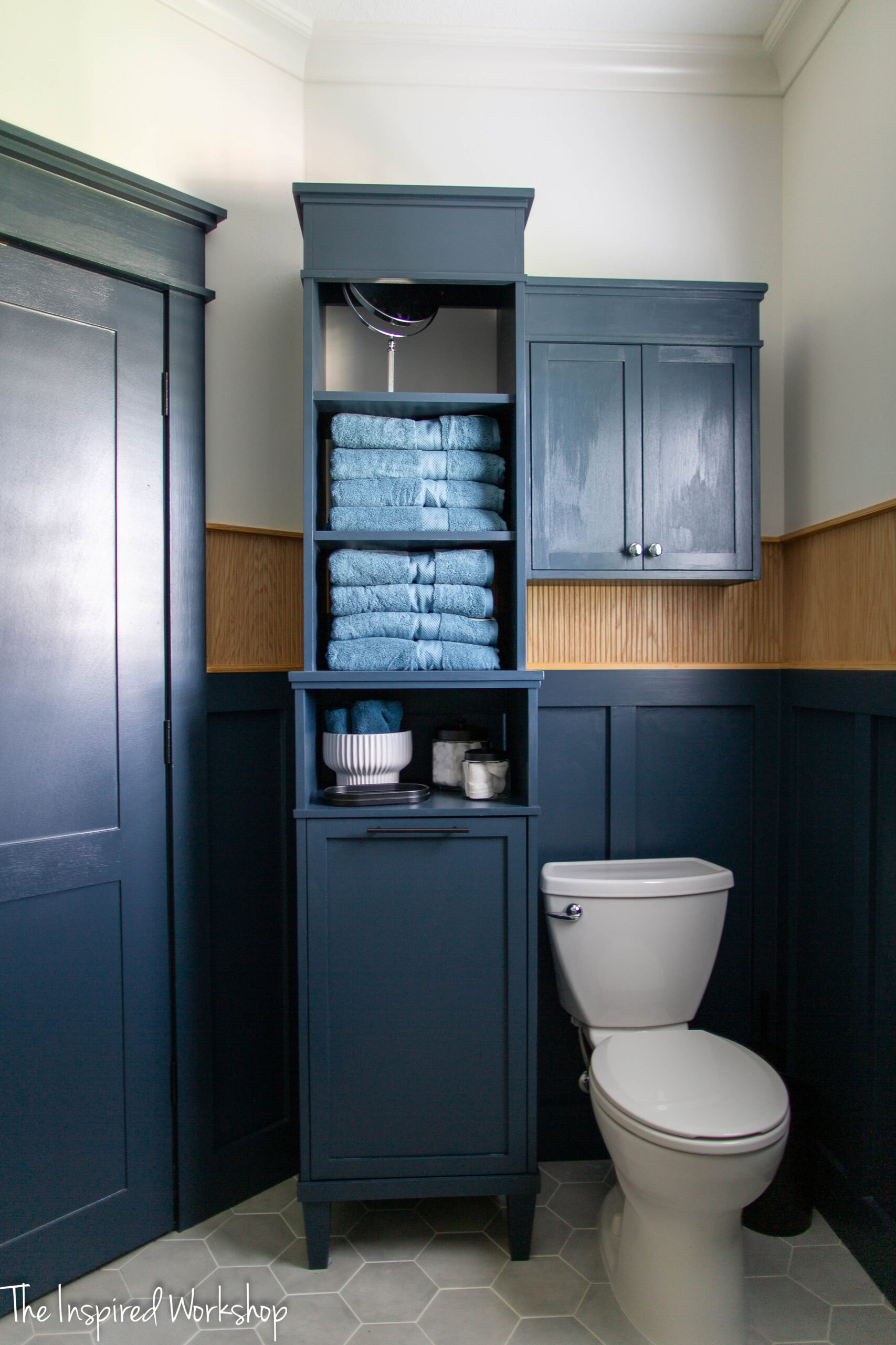 linen tower and toilet with over the toilet cabinet above it
