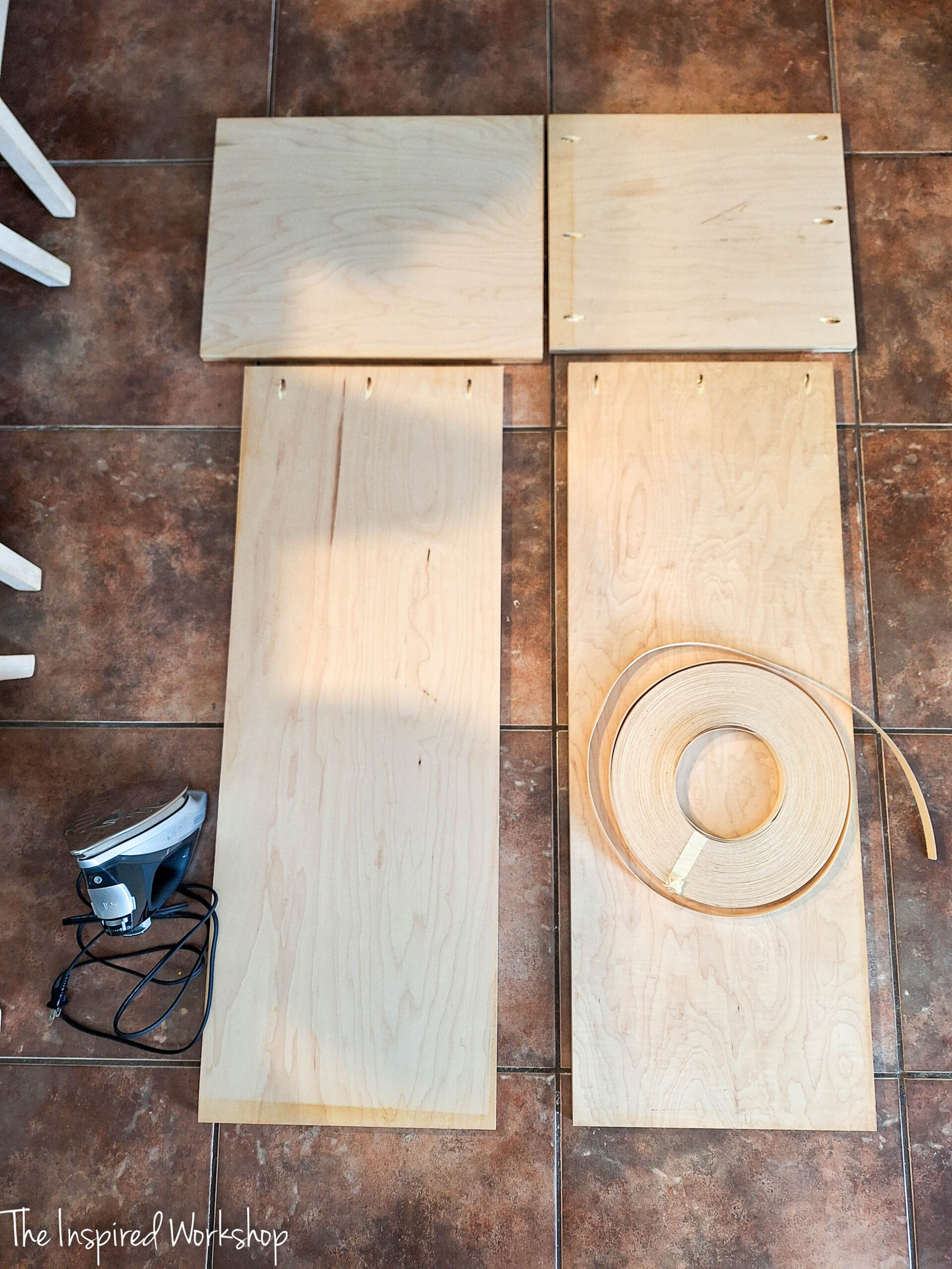 the plywood pieces laying on the floor to build the base of the linen cabinet