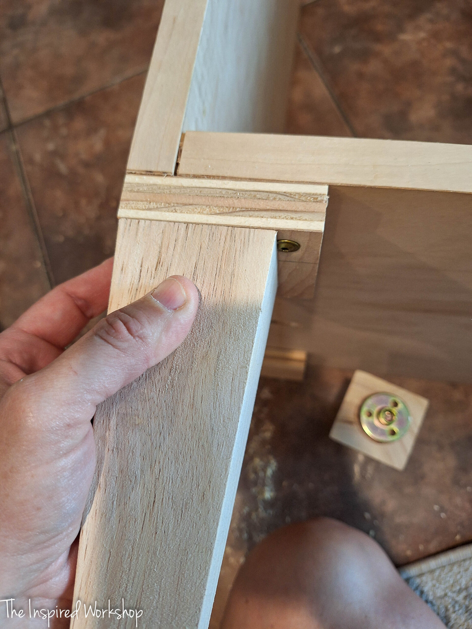 furniture foot screwed into the linen cabinet