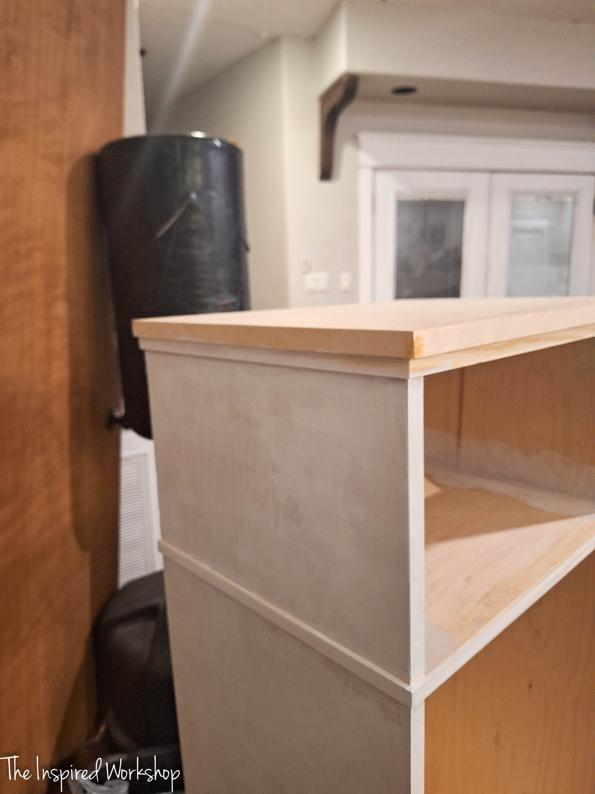 the trim added to the base cabinet of the linen cabinet