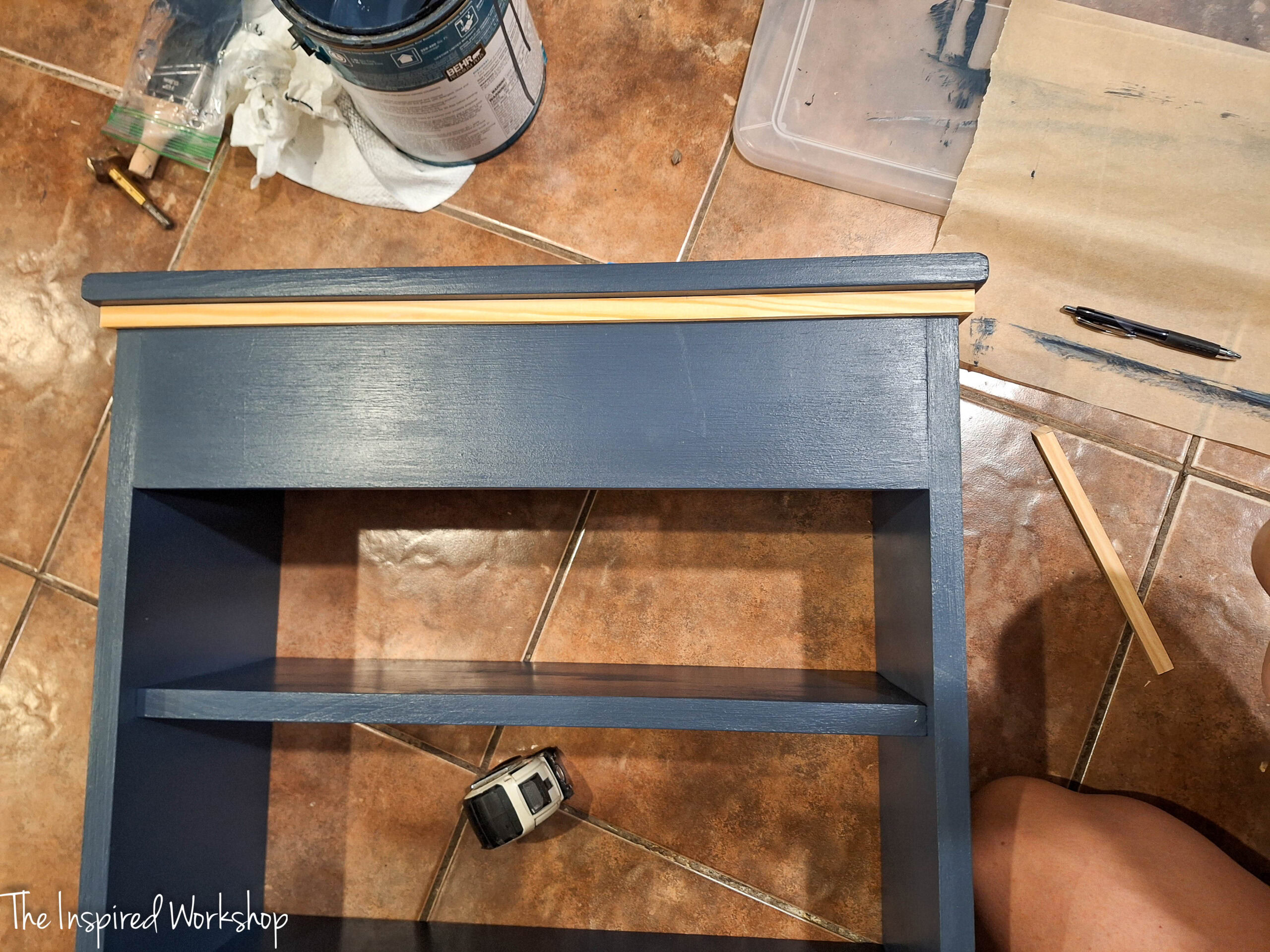 adding trim to the over the toilet cabinet