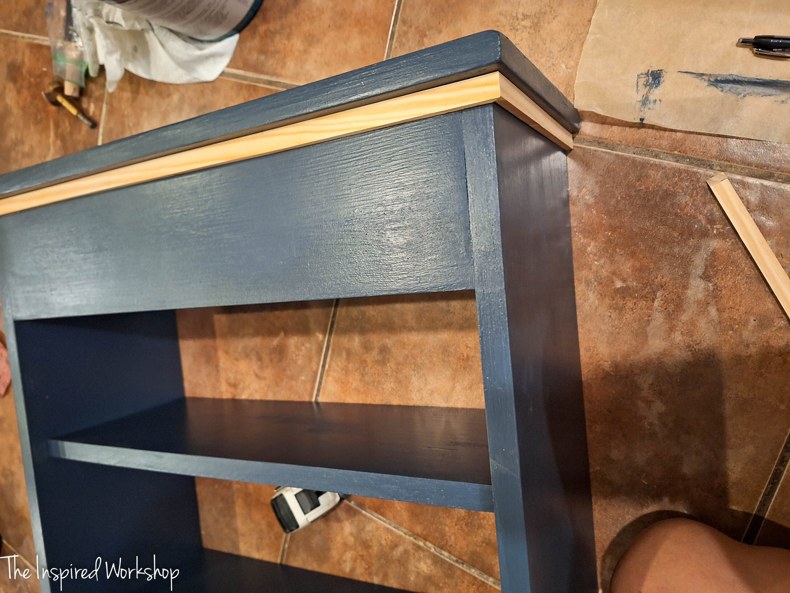 showing the unpainted trim on the over the toilet cabinet