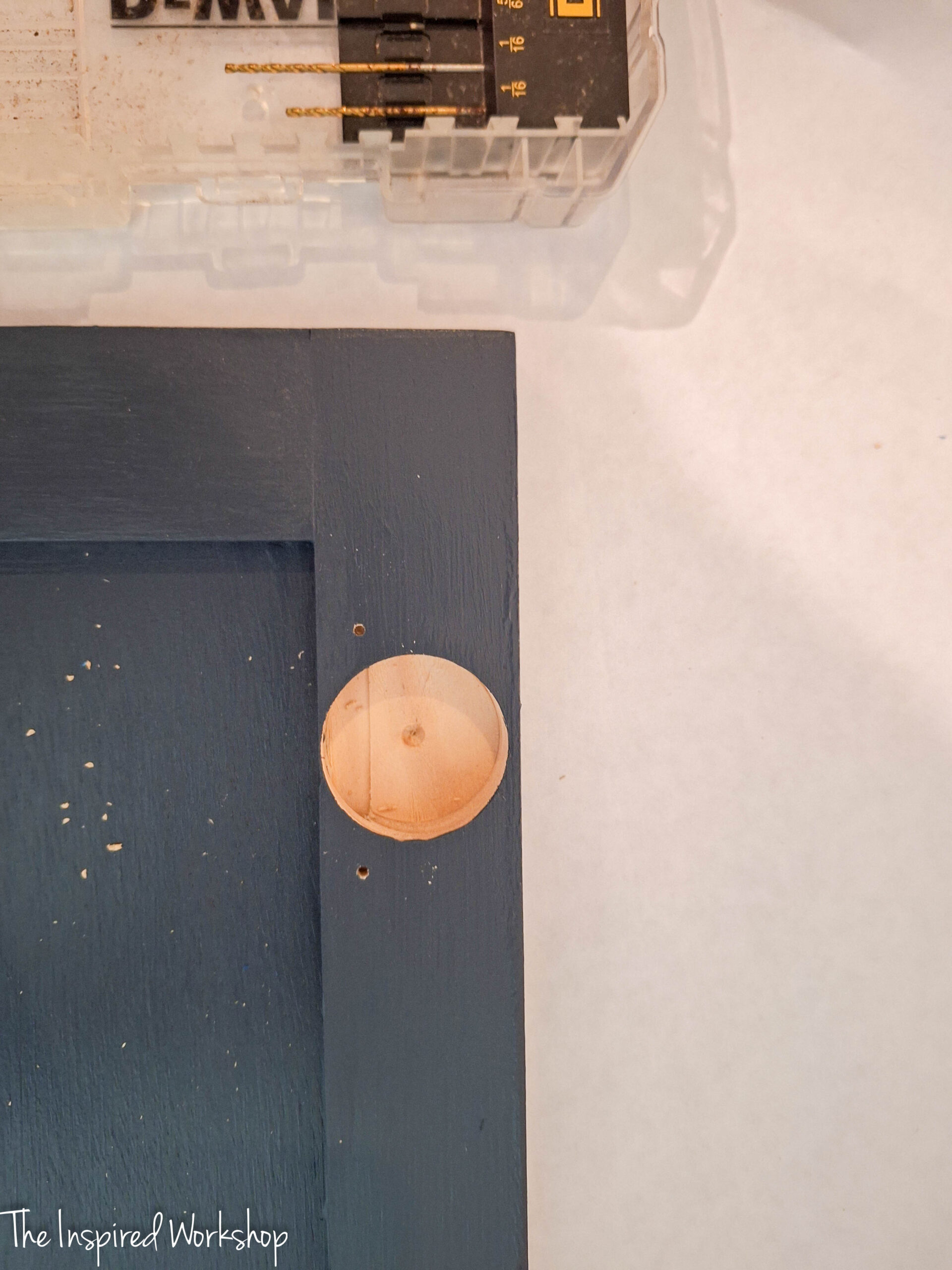 showing the hole drilled in the cabinet door after using the kreg cabinet hinge jig