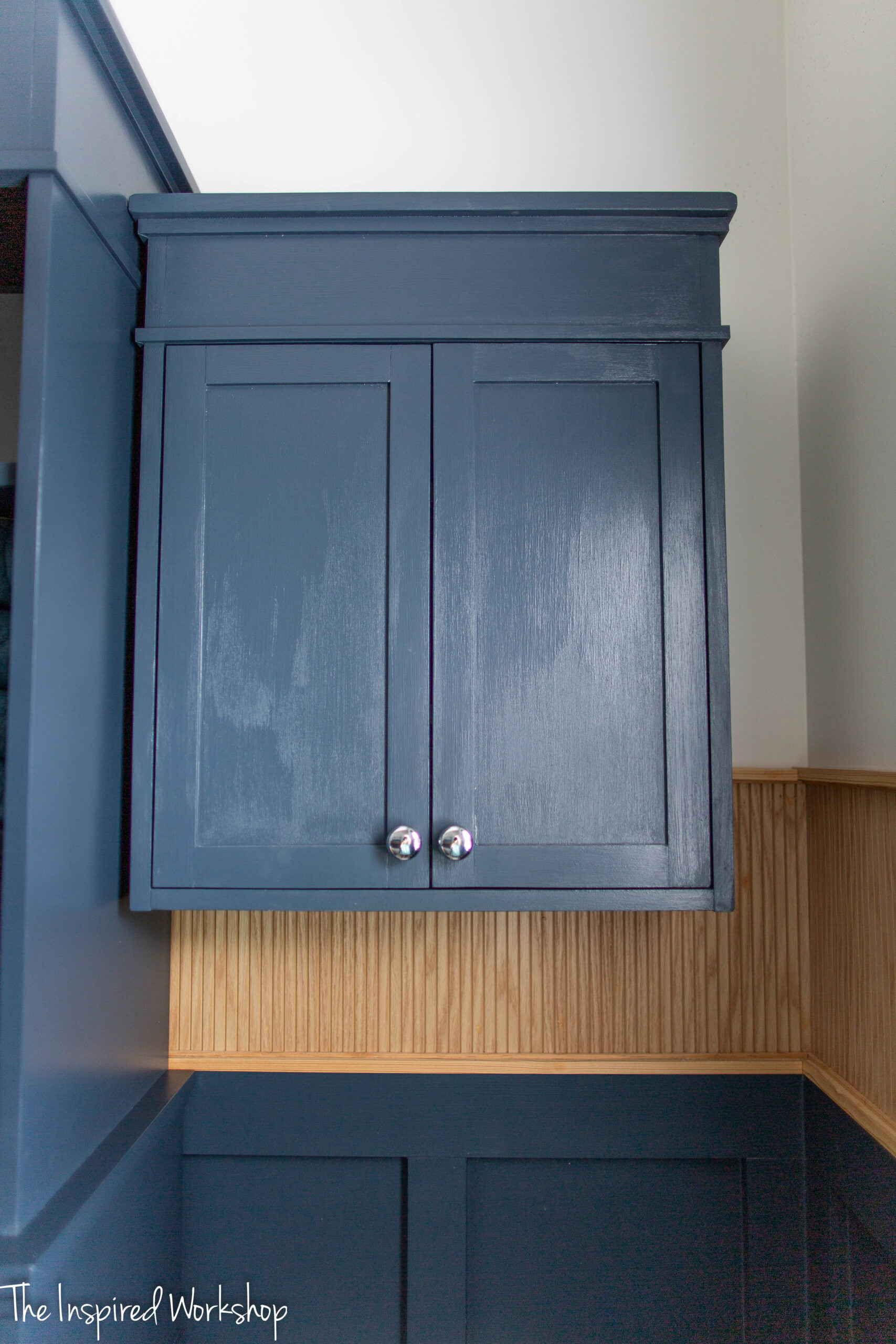 the over the toilet cabinet up against the storage cabinet