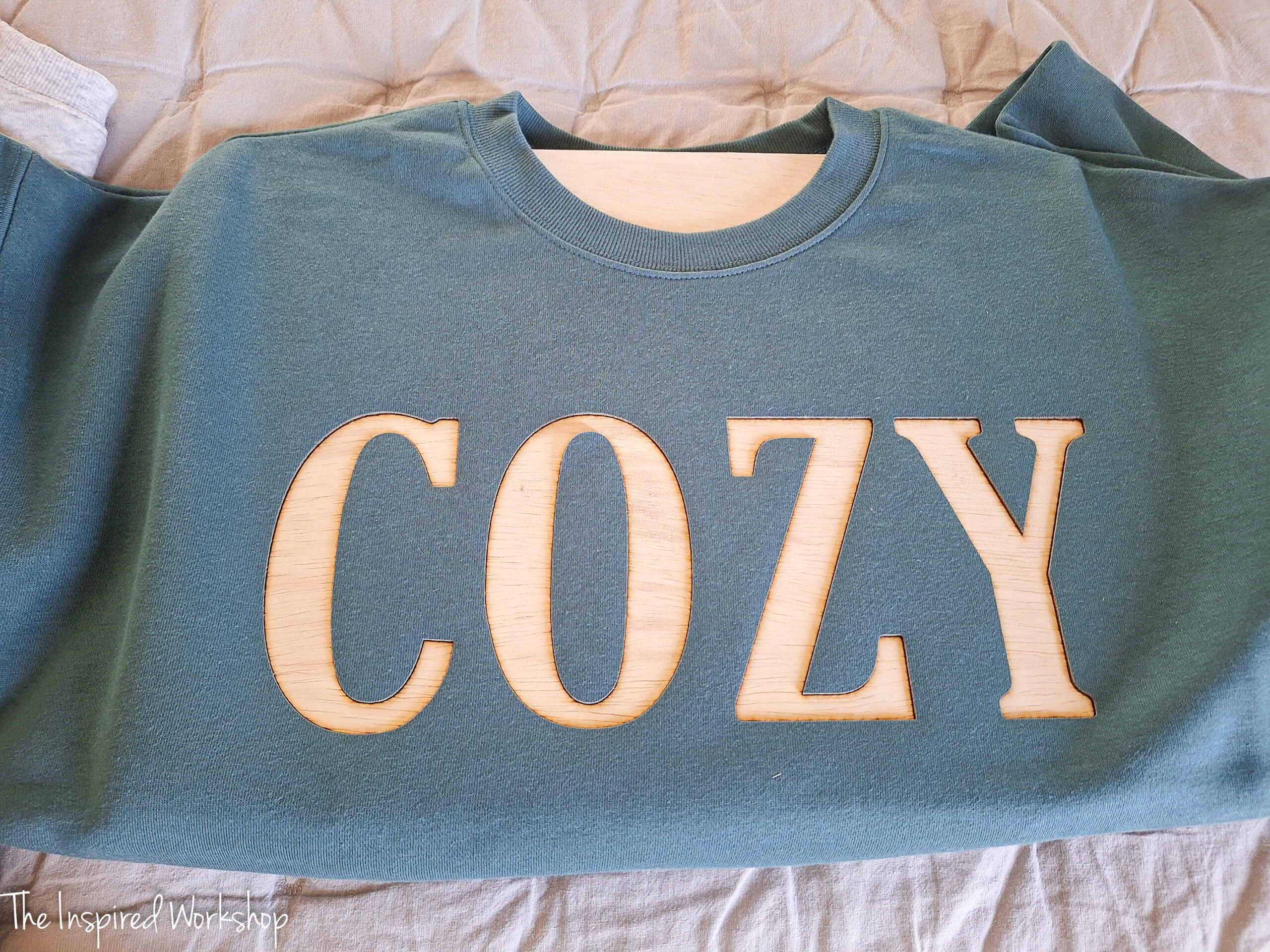 sweatshirt with the word "cozy" cut into it with the xTool M2
