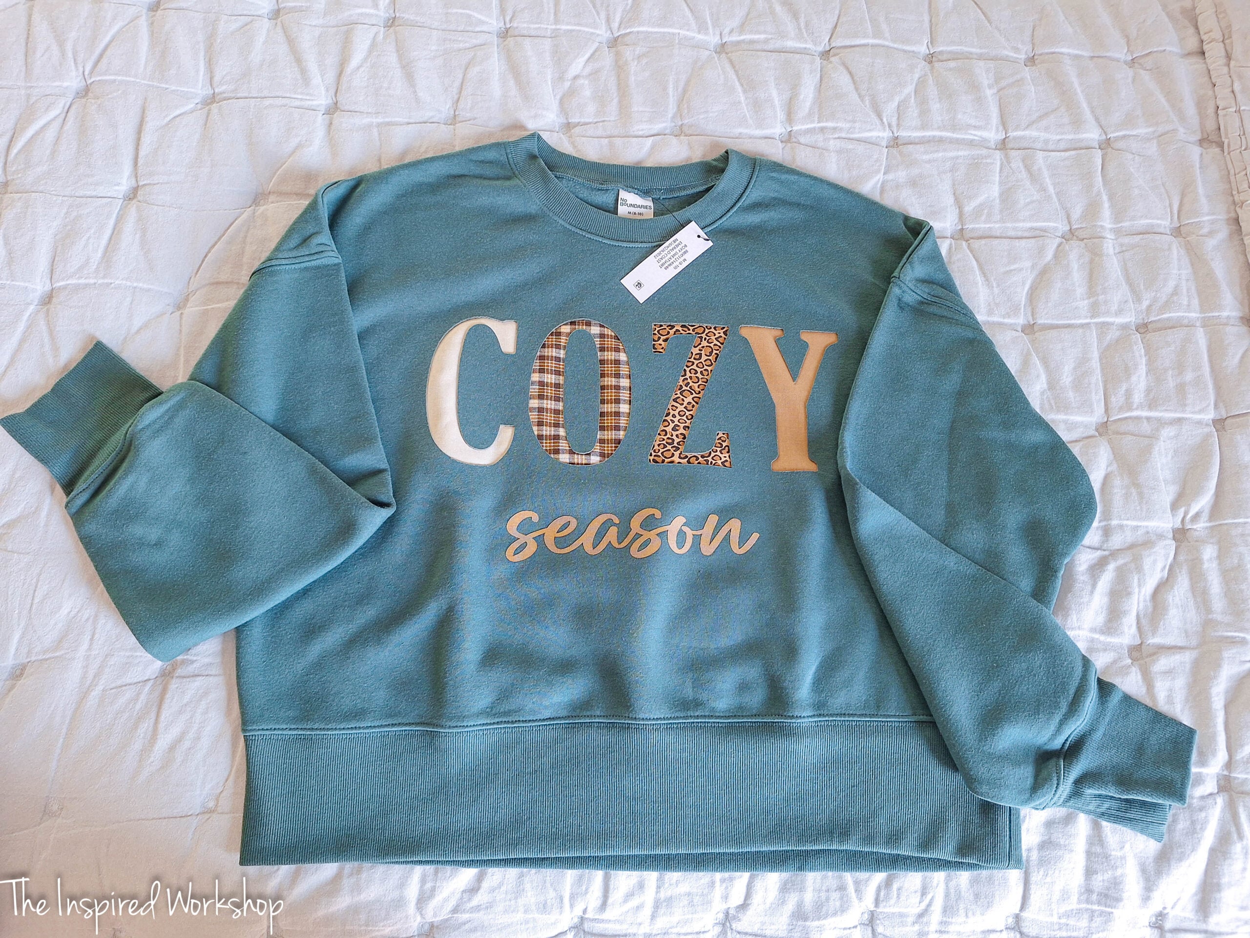 green sweatshirt with the word "cozy" on it in different printed fabrics