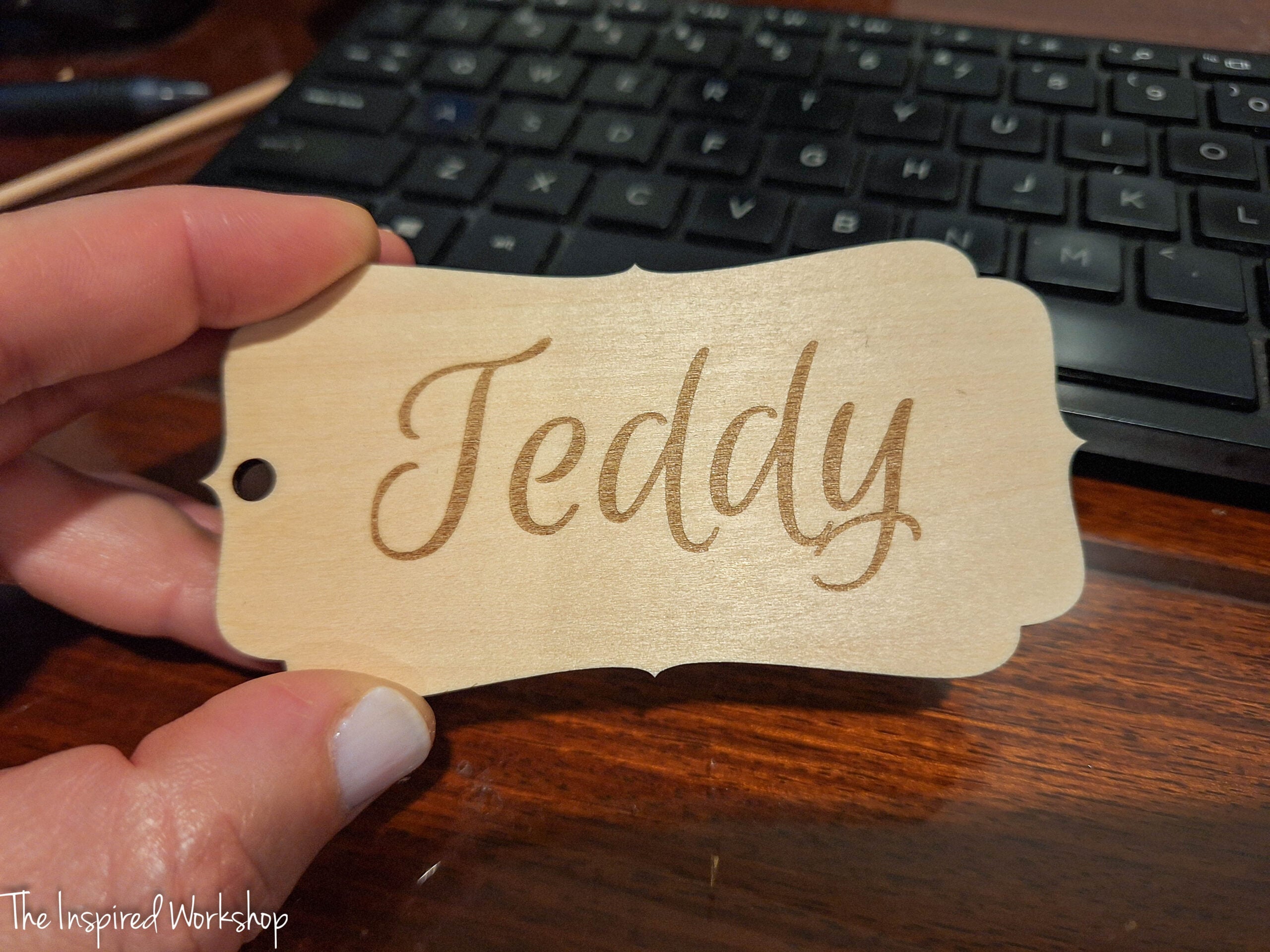 serpentine shape stocking tag made out of wood with the name "Teddy" engraved on it