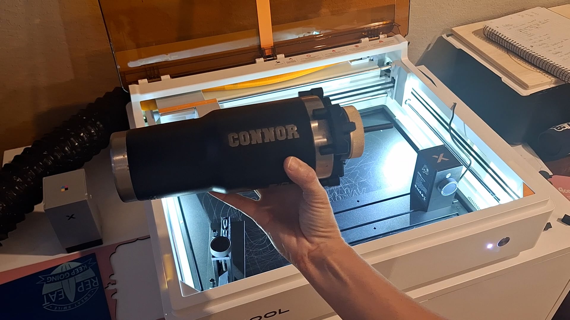 the black tumbler engraved with the name "Connor" on it