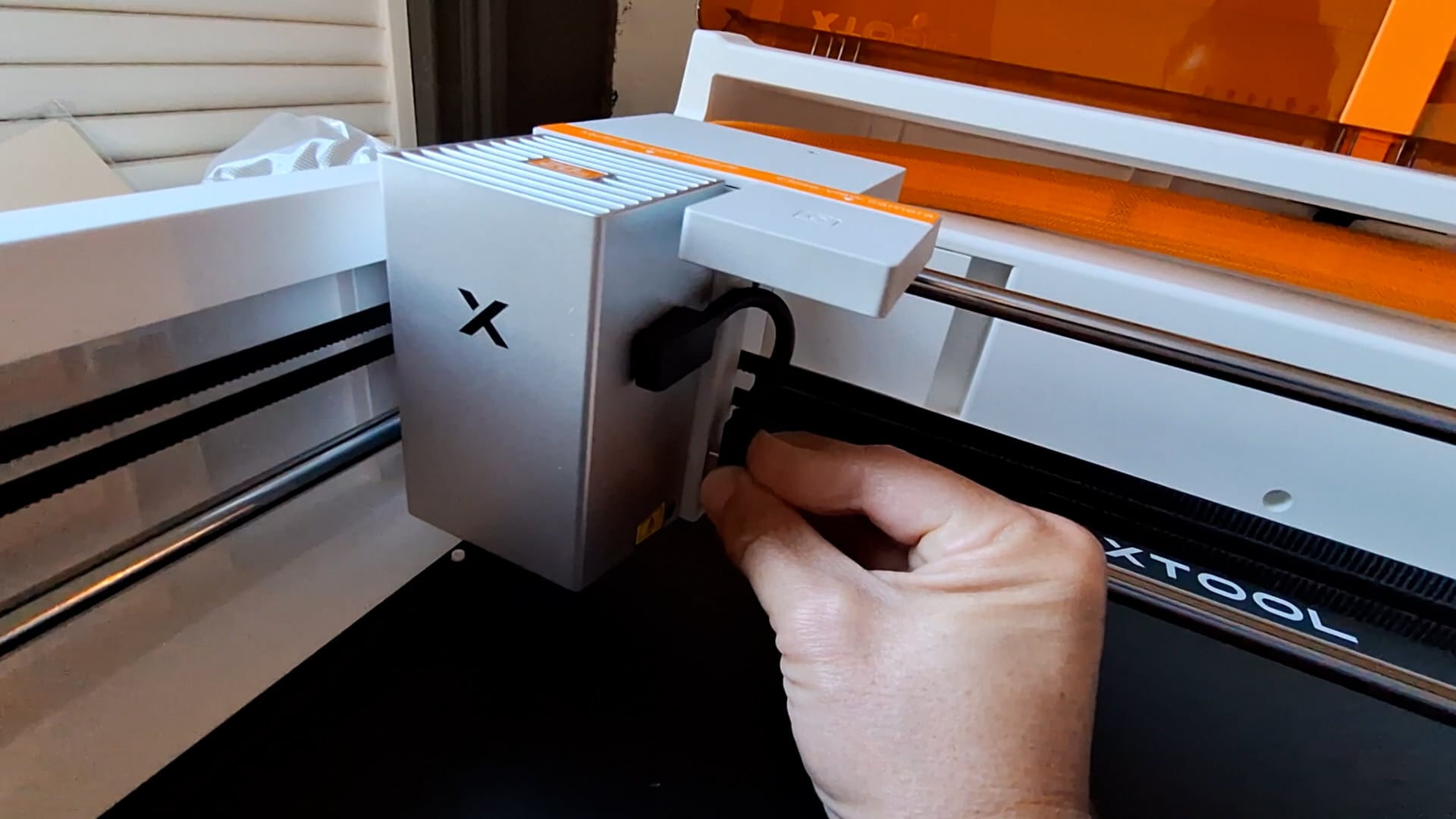 attaching the small cable from the machine to the laser module