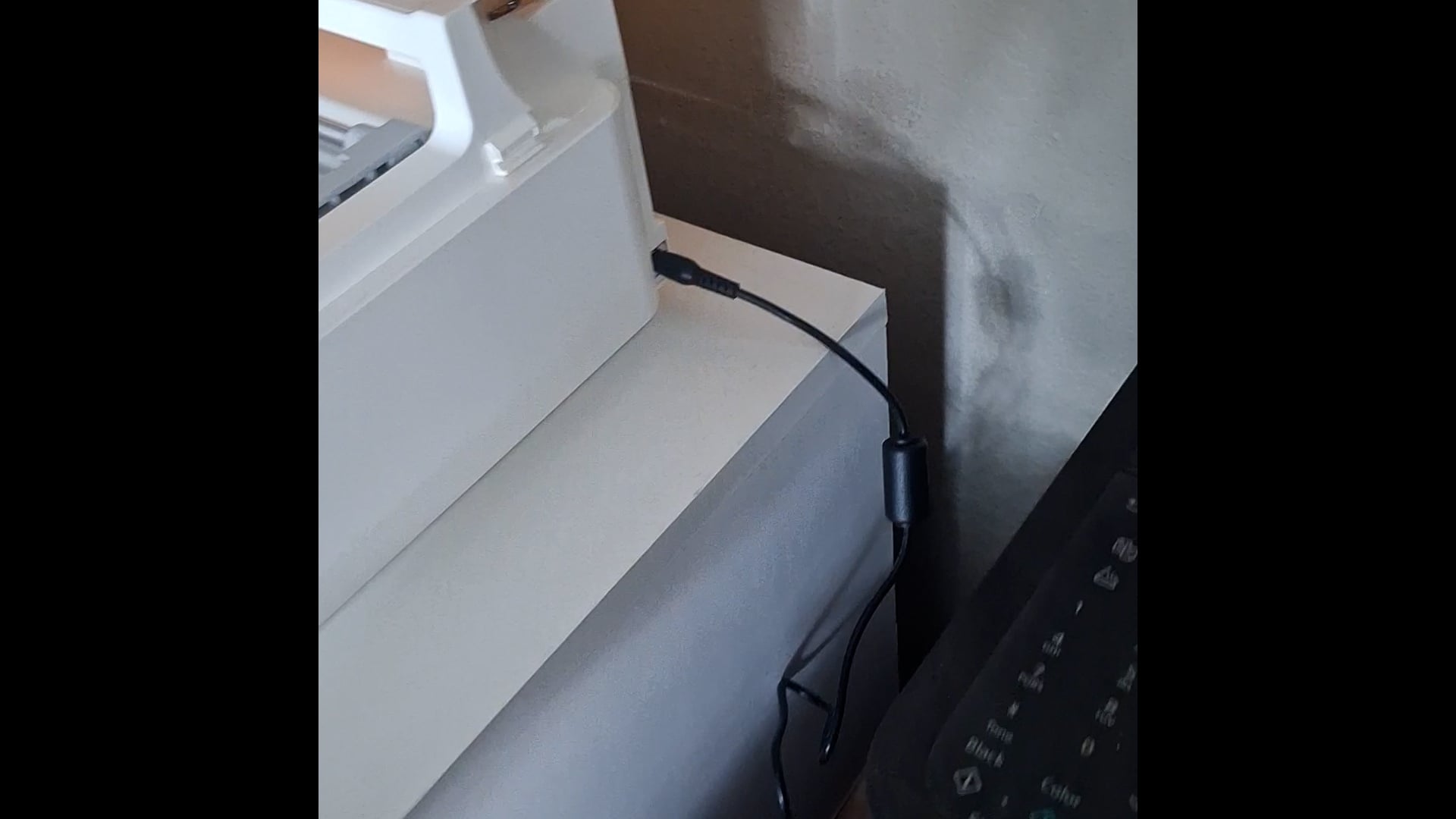 showing where to plug the power cord into the machine