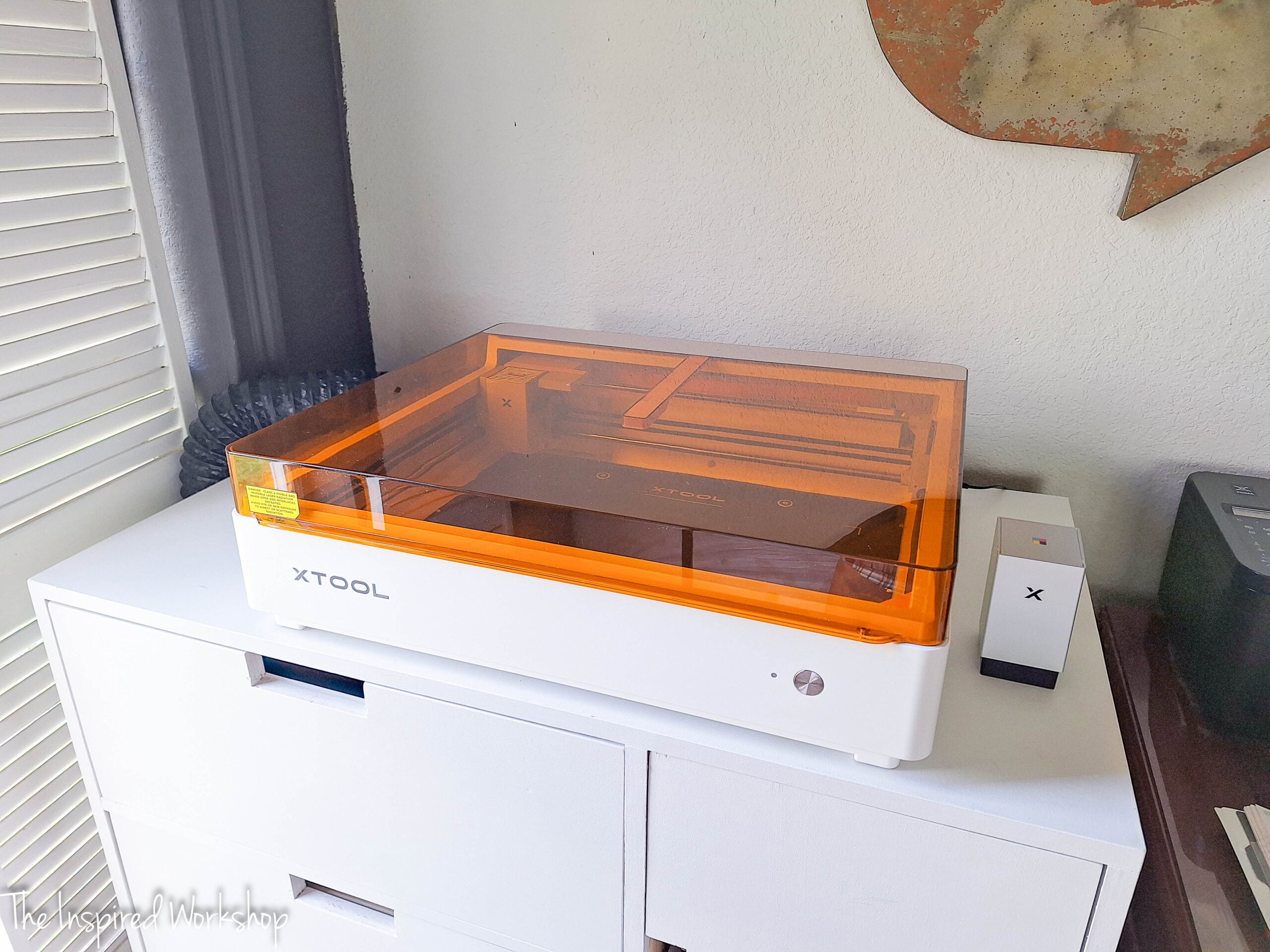 xtool M2 sitting on a white cabinet