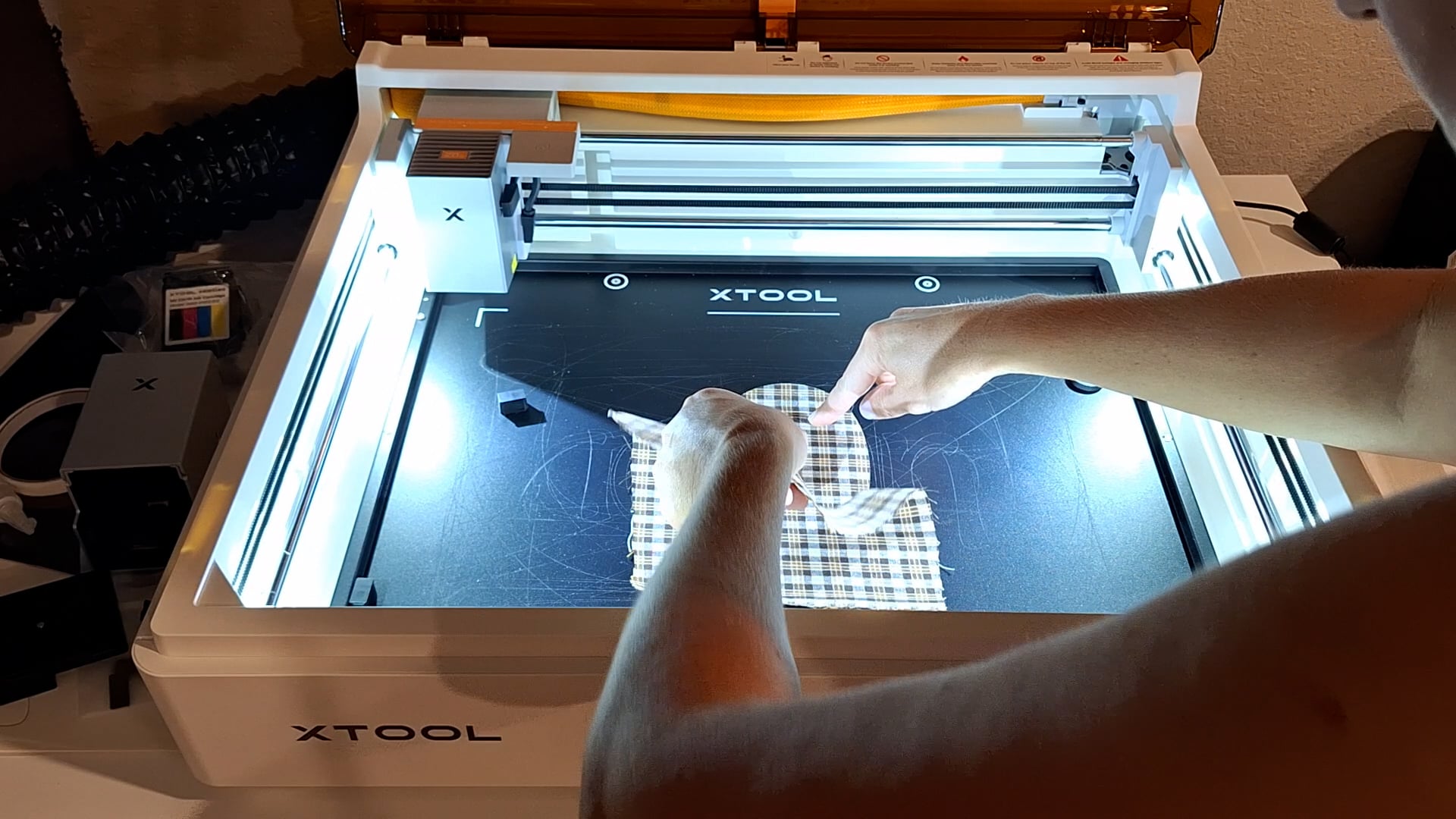 peeling the fabric away from the cut piece inside the xtool M2