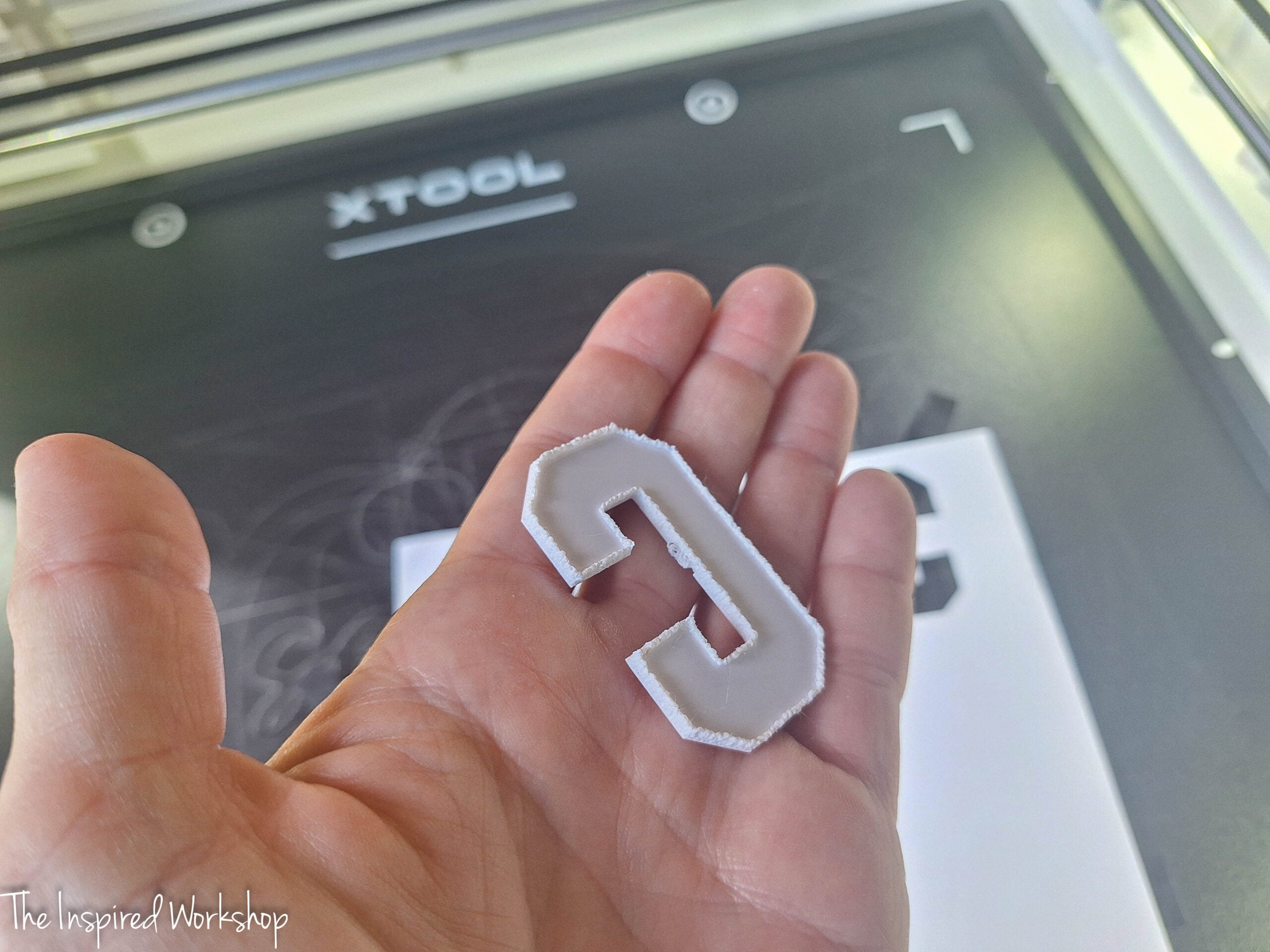 letter C in my hand cut out of white acrylic