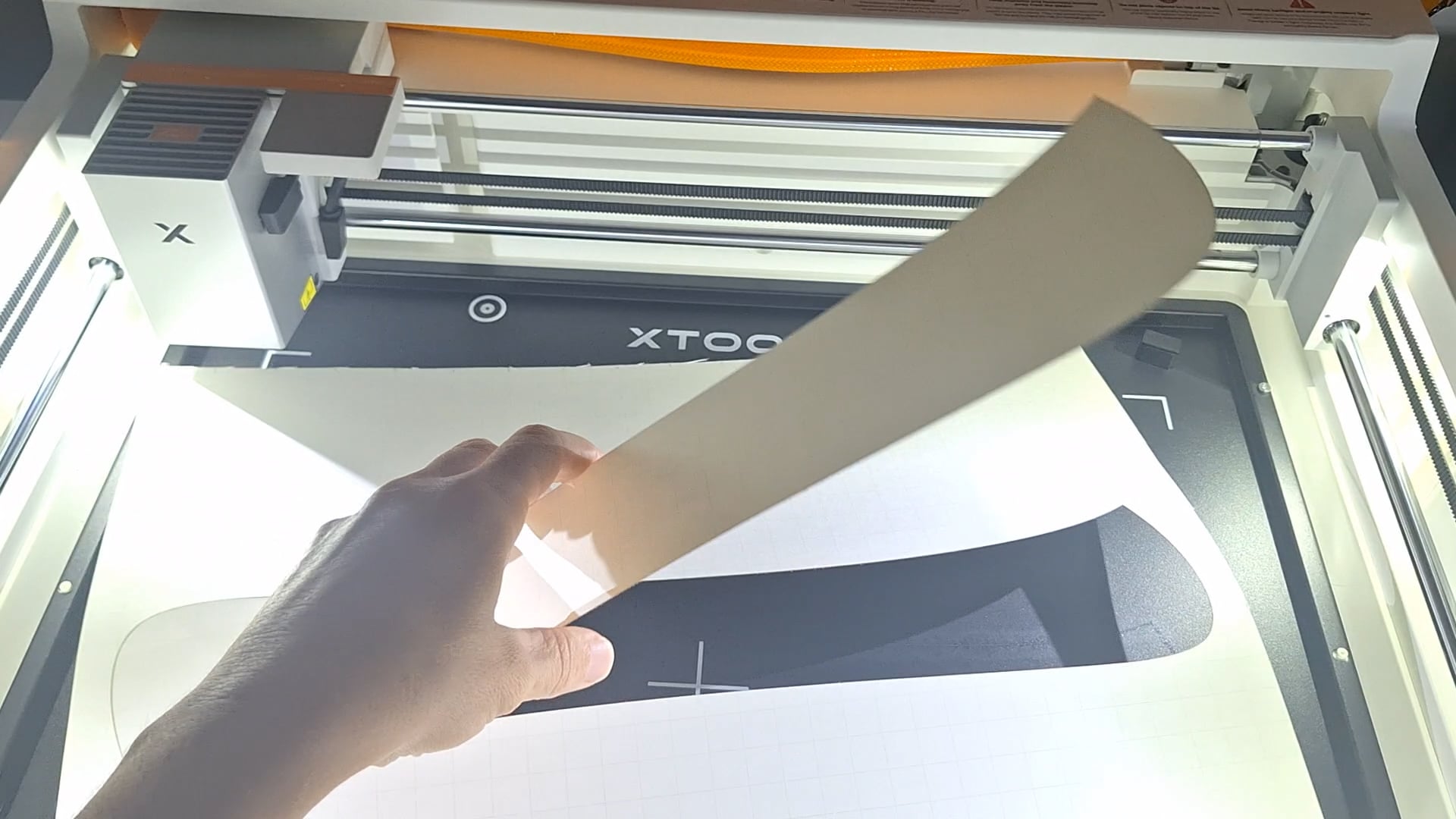 picking up the letter that was cut out of poster board on the xtool m2 laser cutter