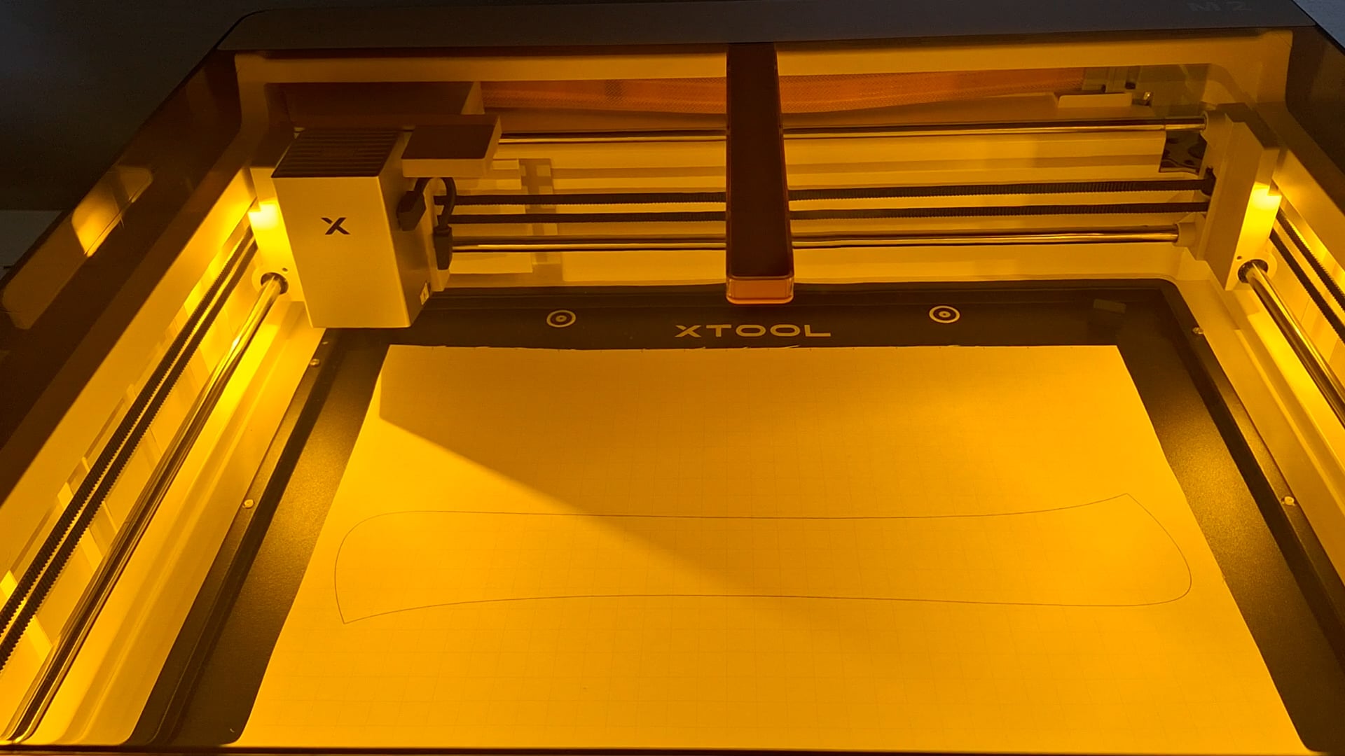cutting poster board with the xTool M2 - poster board is inside the machine being cut